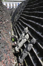 Mexico, Federal District, Mexico City, Stone sculptures and part view of pyramid steps in Templo Mayor Aztec temple ruins.