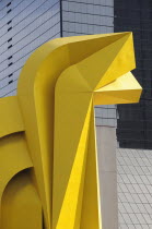 Mexico, Federal District, Mexico City, Detail of yellow Little Horse sculptural form in front of mirrored exterior of Torre Caballito on Reforma.