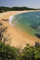 Mexico, Oaxaca, Huatulco, View onto deserted beach at Playa Conejos with turquoise water and golden sand.