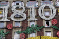 Mexico, Federal District, Mexico City, Majestic Hotel in the Zocalo. Exterior facade displaying silver 1810, the date of Independence and red, green and gold decorations.