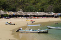Mexico, Oaxaca, Huatulco, Tour boats and beach side restaurants on Playa La Entrega.