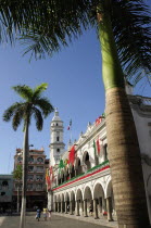 Mexico, Veracruz, Palm trees in the zocalo and government buildings decorated with national colours.
