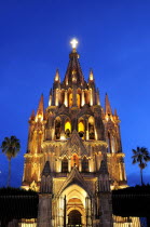 Mexico, Bajio, San Miguel de Allende, La Parroquia de San Miguel Arcangel neo-gothic exterior illuminated at night.
