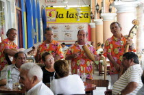 Mexico, Veracruz, Marimba band playing in the Zocalo for people seated at cafe tables.
