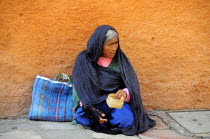 Mexico, Bajio, San Miguel de Allende, Woman begging on street corner.