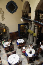 Mexico, Puebla, Looking down on diners in courtyard of Hotel Colonial.