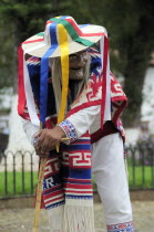Mexico, Michoacan, Patzcuaro, Figure wearing mask and costume performing Danza de los Viejitos or Dance of the Little Old Men in Plaza Vasco de Quiroga.
