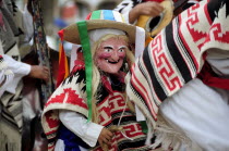 Mexico, Michoacan, Patzcuaro, Child wearing mask and costume for Danza de los Viejitos or Dance of the Little Old Men in Plaza Vasco de Quiroga.