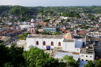 Mexico, Veracruz, Papantla, Views over Cathedral, Zocalo and surrounding buildings set amongst trees.