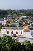 Mexico, Veracruz, Papantla, Views over Cathedral, Zocalo and surrounding buildings set amongst trees.