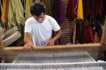 Mexico, Oaxaca, Teotitlan del Valle, Weaver at loom.