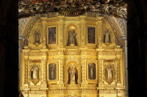 Mexico, Oaxaca, Church of Santo Domingo, Interior with carved and gilded altarpiece with paintings and painted, sculpted, figures.