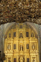 Mexico, Oaxaca, Church of Santo Domingo, Ornately decorated interior with carved and gilded altarpiece.