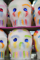Mexico, Puebla, Sugar candies in the shape of skulls for Dia de los Muertos or Day of the Dead festivities.
