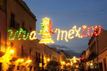 Mexico, Bajio, Zacatecas, Coloured lights hung across street for Independence Day celebrations.