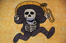 Mexico, Bajio, Queretaro, Wall art depicting skeleton in sombrero holding a trumpet.