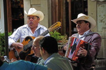 Mexico, Bajio, Guanajuato, Mariachi musicians playing at cafe in Jardin de la Union.