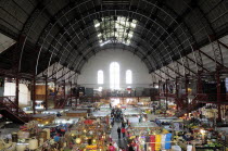 Mexico, Bajio, Guanajuato, Busy interior of Mercado Hidalgo with stalls spread out beneath domed roof supported by metal structure.