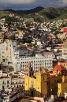 Mexico, Bajio, Guanajuato, Elevated view of Basilica and university building with barrios on hillside beyond from panaoramic viewpoint.