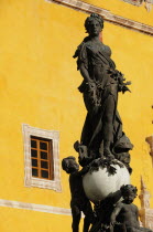 Mexico, Bajio, Guanajuato, Belle Epoque statue of Peace in Plaza de la Paz, the Plaza of Peace also known as Plaza Mayor. With yellow exterior wall of Basilica Colegiata de Nuestra Senora de Guanajuat...