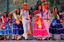 Mexico, Jalisco, Guadalajara, Plaza Tapatia, Folkloric dancers from Guerrero State wearing brightly coloured costume, performing at carnival.