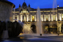 Mexico, Jalisco, Guadalajara, Fountain in foreground of exterior facade of Presidencia Municipal building at night on Plaza Guadalajara.