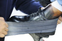 Mexico, Jalisco, Guadalajara, Plaza de la Liberacion, Cropped view of shoe shine at work.