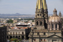 Mexico, Jalisco, Guadalajara, View of Cathedral dome and twin spires with city to the north and Plaza Guadalajara in near distance.