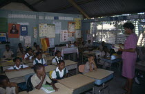 West Indies, Jamaica, Falmouth, first grade pupils in classroom with female teacher.