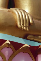 Thailand, Koh Samui, large golden seated buddha with detail of hand and colourful base.