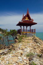 Thailand, Koh Samui, Choeng Mon Bay, Samui peninsula resort, stone path leading up to massage spa house with ornate roof overlooking the beach.