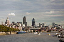 England, London, Skyline with view across the thames towards Blackfriars bridge from left to right St Pauls Cathedral, Tower 42 and Swiss RE tower. boats on the water in the foreground Tower 42 formal...