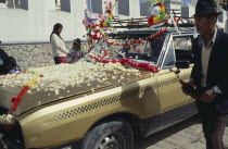 Bolivia, La Paz, Copacabana, car blessing ceremony, car with bonnet covered in flower petals.