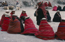 Bolivia, La Paz, Amarete, Fiesta de San Felipe held on May 1st, group of women wearing red woven shawls seated in circle.