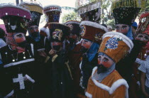 Mexico, Morelos, Cuernavaca, La Fiesta de la Asoncion de Maria, masked group outside during festival.