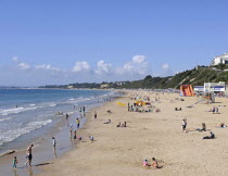 England, Dorset, Bournemouth, View over beach with families sunbathing and Life Guard station.