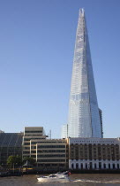 England, London, Southwark southbank, Pleasure boat passing the Shard skyscraper designed by Renzo Piano in the city's London Bridge Quarter.