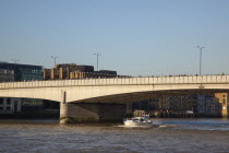 England, London, Southwark southbank, early morning commuters crossing London Bridge to get to the City Financial District.