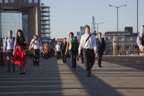 England, London, Early morning commuters crossing London Bridge towards the City Financial district.