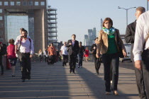 England, London, Early morning commuters crossing London Bridge towards the City Financial district.