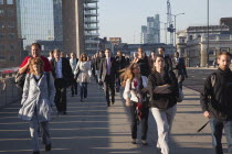 England, London, Early morning commuters crossing London Bridge towards the City Financial district.