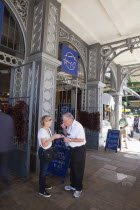 England, London, Southwark, Borough Market, Londons oldest fresh fruit and vegetable market, tourists eating Iberico Jamon outside Brindisa store.