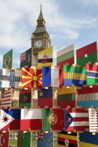 England, London, Parliament Square, Sculpture containing flags of competing Olympic nations with Big Ben behind.