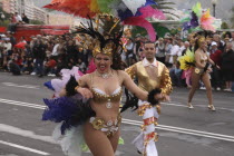 Spain, Canary Islands, Tenerife, Santa Cruz Latin carnival female dancer with feather costume.