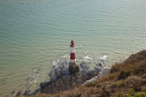 England, East Sussex, Beachy Head lighthouse seen from the cliff top.