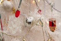 Religion, Festival, Christmas, Detail of tree decorated with lights, tinsel and various baubles.