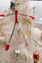 Religion, Festival, Christmas, Detail of tree decorated with lights, tinsel and various baubles.