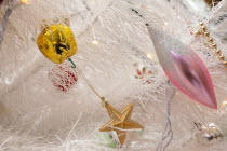 Religion, Festival, Christmas, Detail of tree decorated with lights, tinsel and various baubles.