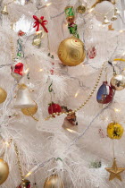 Religion, Festival, Christmas, Detail of tree decorated with lights, tinsel and various baubles.