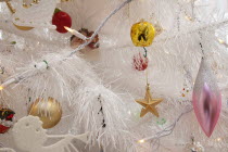 Religion, Festival, Christmas, Detail of tree decorated with lights, tinsel and various baubles.